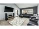 Spacious living room with vaulted ceiling, tile flooring and gray sectional sofa at 10008 N 50Th Dr, Glendale, AZ 85302