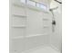 Modern shower featuring a sleek design with built-in shelving and a handheld showerhead for convenience at 10008 N 50Th Dr, Glendale, AZ 85302