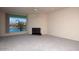 Bright living room with a fireplace and a large window overlooking the water at 10080 E Mountain View Lake Dr # 138, Scottsdale, AZ 85258