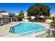Large community pool with lounge chairs surrounded by green trees at 10080 E Mountain View Lake Dr # 138, Scottsdale, AZ 85258