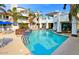 Community pool surrounded by manicured landscaping and white buildings at 10080 E Mountain View Lake Dr # 138, Scottsdale, AZ 85258