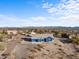 Eye-catching aerial view of a home with a three-car garage nestled within the desert landscape at 1100 W Palo Verde Dr, Wickenburg, AZ 85390