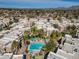 Gorgeous aerial view of community featuring sparkling pool, palm trees, and mountain views at 11333 N 92Nd St # 2072, Scottsdale, AZ 85260