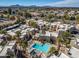 Scenic aerial view of a community pool, lush landscaping, and mountain backdrop at 11333 N 92Nd St # 2072, Scottsdale, AZ 85260