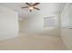 A carpeted bedroom with a ceiling fan and light, one window with blinds, and white walls in a condo at 11333 N 92Nd St # 2072, Scottsdale, AZ 85260