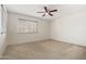 A carpeted bedroom with a ceiling fan, one window with blinds, and white walls in a condo at 11333 N 92Nd St # 2072, Scottsdale, AZ 85260