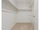 A closet with rods and shelves for storage, carpet, and a white door in a condo at 11333 N 92Nd St # 2072, Scottsdale, AZ 85260