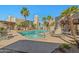 A luxurious community pool boasts a tranquil spa and abundant lounge seating amidst lush, tropical landscaping at 11333 N 92Nd St # 2072, Scottsdale, AZ 85260