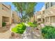 Charming condo courtyard featuring walkways, green grass, mature trees, and desert landscaping on a clear day at 11333 N 92Nd St # 2072, Scottsdale, AZ 85260