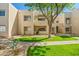 A well-maintained condo building with fresh green grass and tasteful desert landscaping on a sunny day at 11333 N 92Nd St # 2072, Scottsdale, AZ 85260
