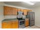 Kitchen with oak cabinets, stainless steel appliances, and tile flooring at 11333 N 92Nd St # 2072, Scottsdale, AZ 85260