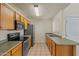 Kitchen featuring oak cabinets, stainless steel appliances, and tile flooring and countertops at 11333 N 92Nd St # 2072, Scottsdale, AZ 85260