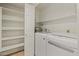 Functional laundry room with shelving, including a washer, dryer, and water heater at 11333 N 92Nd St # 2072, Scottsdale, AZ 85260