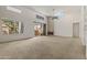 Open living room features a ceiling fan, fire place, a window, and a sliding glass door to a patio at 11333 N 92Nd St # 2072, Scottsdale, AZ 85260