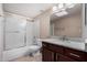 Well-maintained bathroom with granite counters, updated lighting, and shower-tub combo at 1317 E Cobb Dr, Tempe, AZ 85288