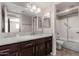 Modern bathroom featuring granite counters, updated lighting, and shower-tub combination at 1317 E Cobb Dr, Tempe, AZ 85288