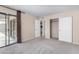 Sunlit bedroom with sliding glass doors, a spacious closet, and neutral decor creates a serene atmosphere at 1317 E Cobb Dr, Tempe, AZ 85288