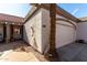 Close up of an attached garage near the front door of a home with desert landscaping and a red tile roof at 1317 E Cobb Dr, Tempe, AZ 85288