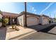View of a home with an attached garage, a red tile roof, desert landscaping, and a mature palm tree at 1317 E Cobb Dr, Tempe, AZ 85288