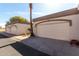 Attached garage with neutral paint and trim complemented by mature desert landscaping under a sunny sky at 1317 E Cobb Dr, Tempe, AZ 85288