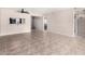 Large living room with tile flooring and ceiling fan; open to the kitchen via a pass-through window at 1317 E Cobb Dr, Tempe, AZ 85288