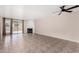 The large living room has tile flooring, a fireplace, a ceiling fan, and access to the backyard at 1317 E Cobb Dr, Tempe, AZ 85288