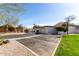 Street view showcasing well-maintained townhomes with parking spots, grass, and a clear sky at 1317 E Cobb Dr, Tempe, AZ 85288