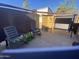 A shady backyard featuring a covered patio swing and comfortable rocking chairs at 1344 W Inuit Ave, Apache Junction, AZ 85119