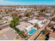 Neighborhood aerial view with pool, landscaping, other homes and mountain views in the distance at 1649 E Dana Ave, Mesa, AZ 85204