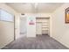 Bedroom showcasing carpet flooring, a closet with shelves, and neutral-colored walls at 1649 E Dana Ave, Mesa, AZ 85204