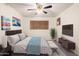 Comfortable bedroom with ceiling fan, ample natural light, and stylish decor creates a serene retreat at 1649 E Dana Ave, Mesa, AZ 85204