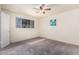 Bedroom with a ceiling fan, carpet flooring, and neutral-colored walls at 1649 E Dana Ave, Mesa, AZ 85204