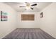 Bedroom with a ceiling fan, carpet flooring, small window, and neutral-colored walls at 1649 E Dana Ave, Mesa, AZ 85204
