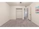 Bedroom with a ceiling fan, carpet flooring, closet and neutral-colored walls at 1649 E Dana Ave, Mesa, AZ 85204