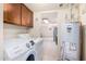 Well-lit laundry room with modern washer, dryer, and storage cabinets at 1649 E Dana Ave, Mesa, AZ 85204