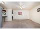 Bright and open living area with tiled floors, a ceiling fan, and easy access to the kitchen at 1649 E Dana Ave, Mesa, AZ 85204