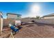 Wide shot of the backyard, featuring a block wall fence and gravel at 17339 W Paraiso Ln, Surprise, AZ 85387