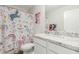 Bathroom featuring a vibrant shower curtain, vanity and quartz countertop at 17339 W Paraiso Ln, Surprise, AZ 85387