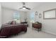 Welcoming bedroom featuring a ceiling fan, window with blinds, and warm lighting at 17339 W Paraiso Ln, Surprise, AZ 85387