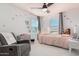 Bright bedroom with a charming pink bed frame and a ceiling fan at 17339 W Paraiso Ln, Surprise, AZ 85387