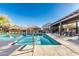 Community pool with an adjacent seating and dining area under a shaded pergola at 17339 W Paraiso Ln, Surprise, AZ 85387