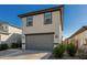 Stylish two-story home with a two-car garage, modern facade, and easy to maintain landscaping at 17339 W Paraiso Ln, Surprise, AZ 85387