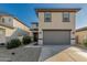 Two-story home showcasing a front-facing two car garage, neutral color scheme, and low-maintenance landscaping at 17339 W Paraiso Ln, Surprise, AZ 85387
