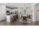 Bright kitchen and dining area with stainless steel appliances, granite countertops, and modern fixtures at 17339 W Paraiso Ln, Surprise, AZ 85387