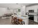Open concept kitchen with island seating, stainless steel appliances, and modern finishes flows into the living room at 17339 W Paraiso Ln, Surprise, AZ 85387