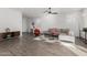 Bright, open living room with wood-look tile floors, modern furniture, and ample natural light at 17339 W Paraiso Ln, Surprise, AZ 85387