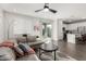 Open concept living area with a view of the kitchen, sliding glass doors to back yard, and modern design at 17339 W Paraiso Ln, Surprise, AZ 85387