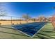 Well-maintained community tennis court surrounded by a secure fence at 17339 W Paraiso Ln, Surprise, AZ 85387
