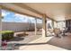 Relaxing outdoor patio area with a low privacy wall, desert landscaping, and space for outdoor dining at 18123 W Hayden Dr, Surprise, AZ 85374