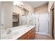 Bathroom featuring double sinks, tile floors, and a large glass shower for a luxurious experience at 18123 W Hayden Dr, Surprise, AZ 85374
